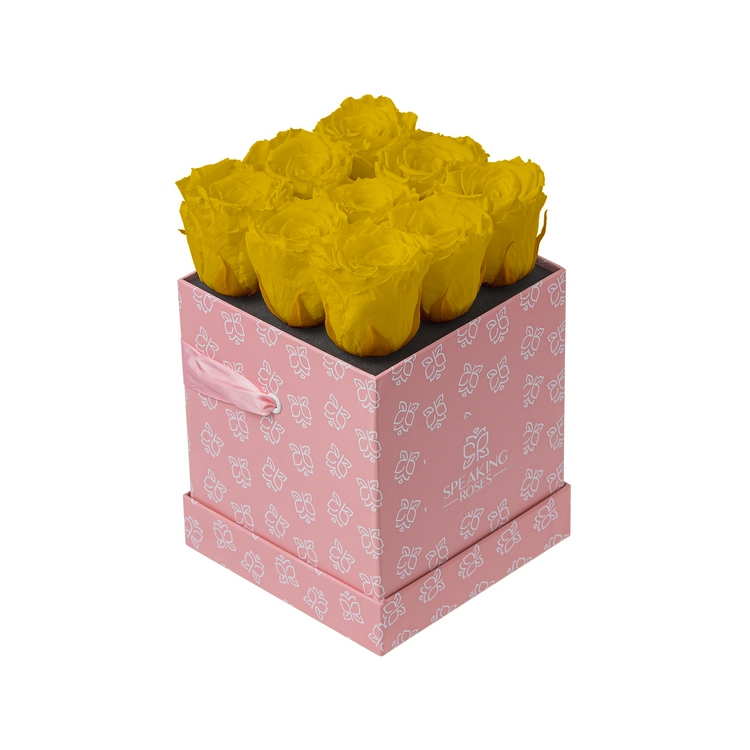 Pink box with yellow roses on a white background