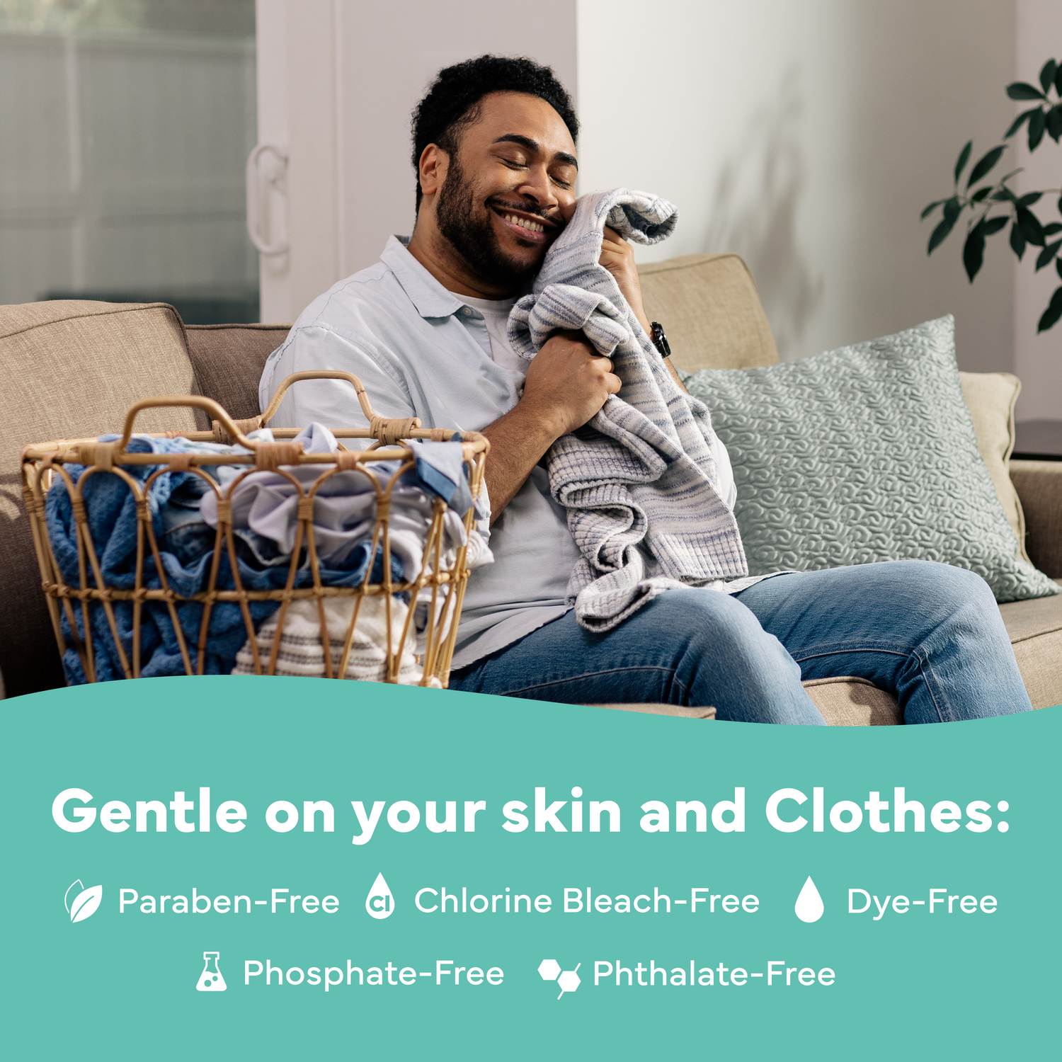Man sitting on a couch with a basket of laundry, smiling, with text about product benefits.
