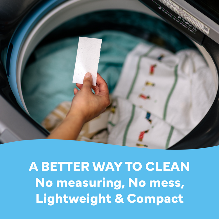Person holding a white card in front of an open washing machine with text about a better cleaning method.