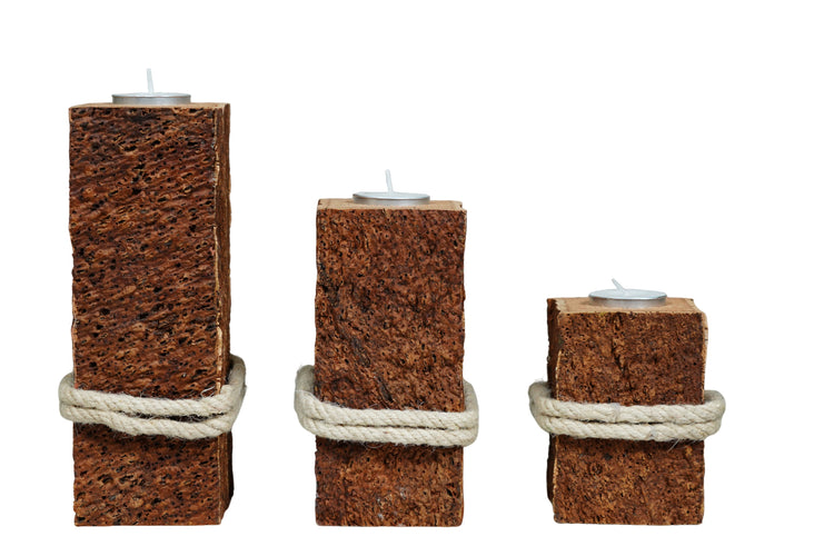 Three square-shaped candle holders made of cork with rope around them on a white background.