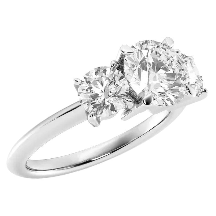 Diamond ring with three clear gemstones on a white background