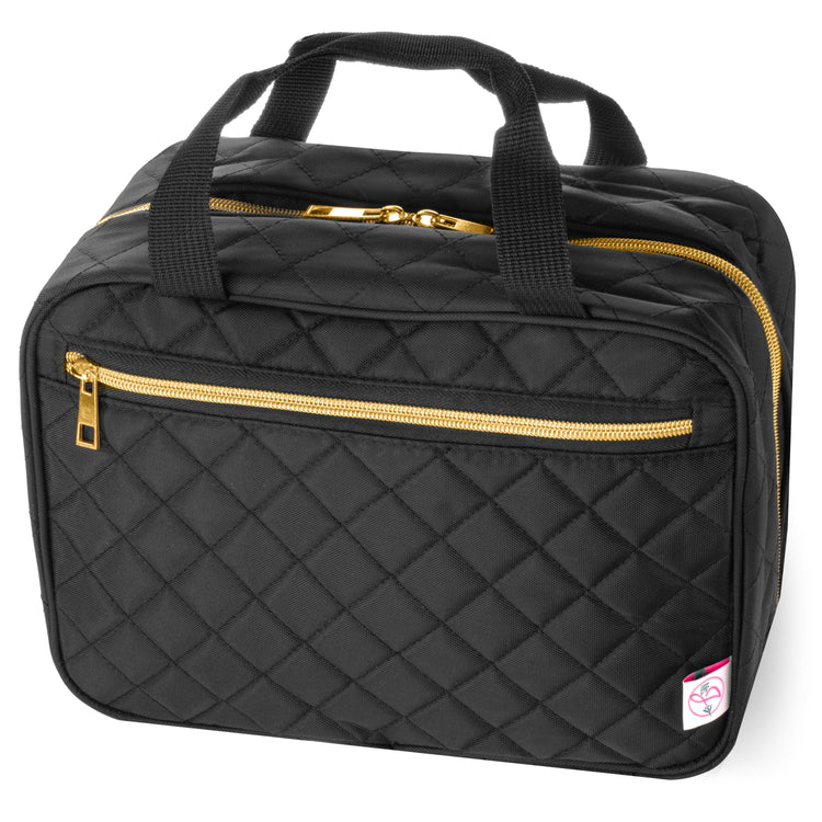 Black quilted travel bag with gold zippers on a white background