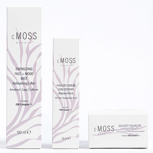 Three white cosmetic product boxes from cMOSS Beauty arranged against a plain white background, including Energizing Face + Mood Mist (100 ml), Pressed Serum Concentrate (30 ml), and Sea Deep Cream Gel.