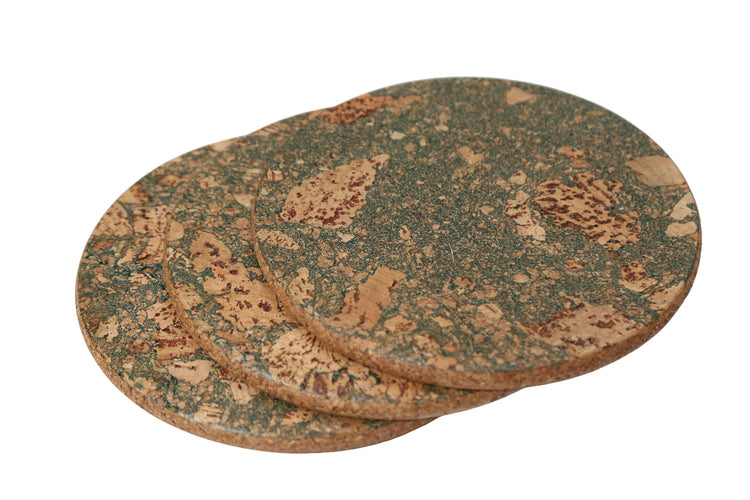 Set of three round cork coasters with a natural pattern on a white background