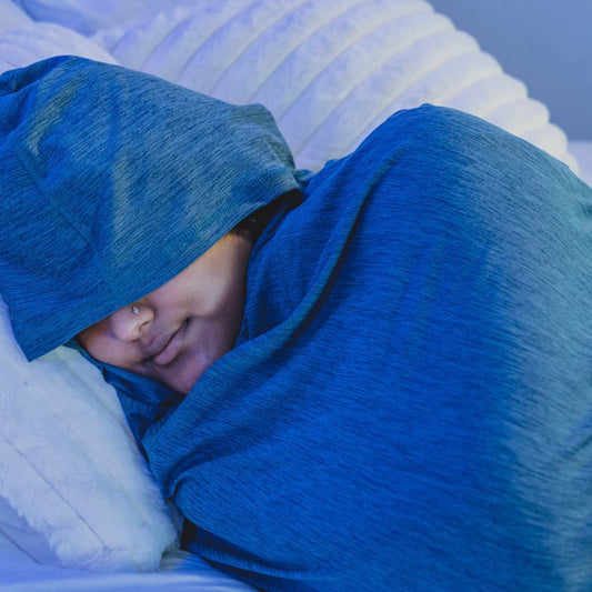 Turquoise#man in Sleep Pod Hood in bed laying down