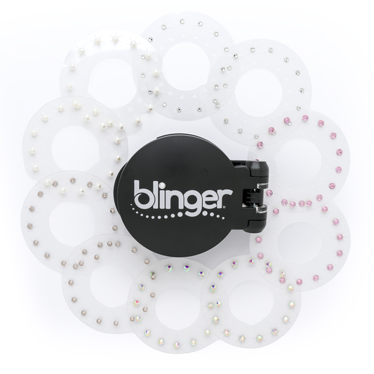 A blinger Vanity Starter Set with a styling tool and a circle of precision-cut glass crystals inside a deluxe black vanity storage case.