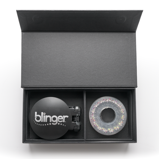 A blinger Vanity Starter Set with a styling tool and a circle of precision-cut glass crystals inside a deluxe black vanity storage case.