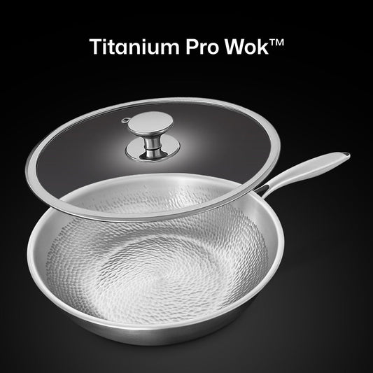 Set of stainless steel cookware including a frying pan, saucepan, and two smaller pots on a white background.