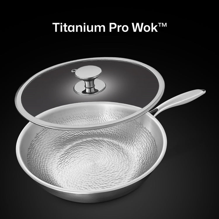 Titanium Pro Wok with lid on a black background