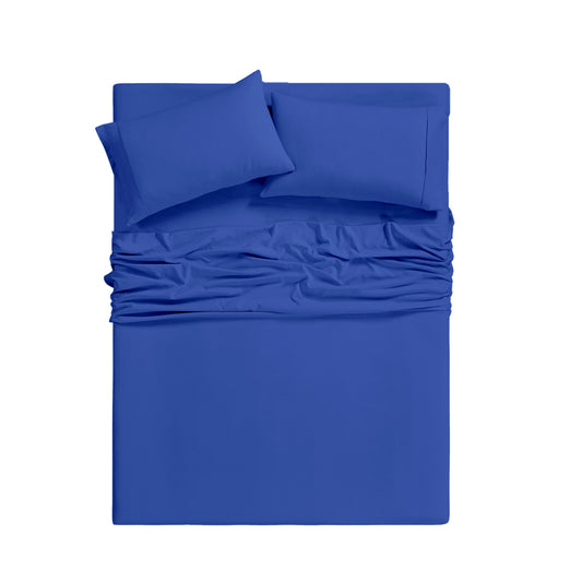 Blue bedding set on a bed in a room with large windows.