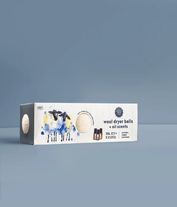 Box of wool dryer balls with oil scents on a gray background