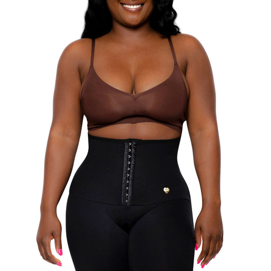 Person wearing a black shapewear garment on a white background