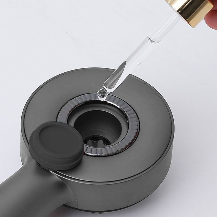 Dropper adding liquid to a gray container on a white background