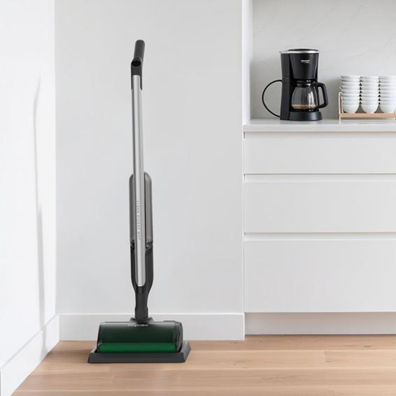 Vacuum cleaner on a wooden floor in a kitchen setting