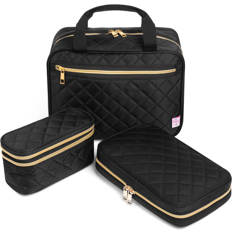 Set of black quilted travel bags with gold zippers on a white background