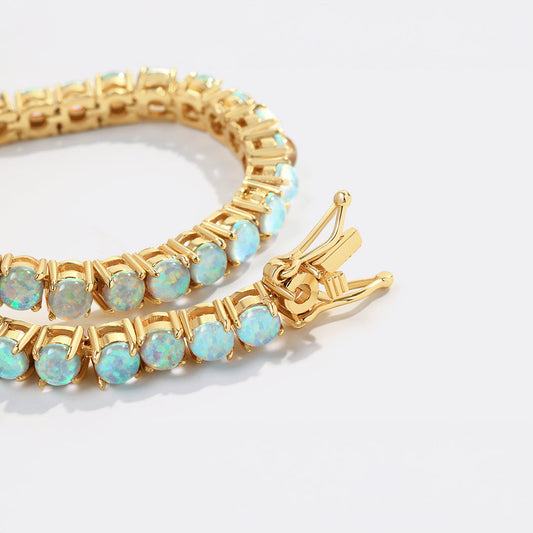 Gold bracelet with opal stones on a white background
