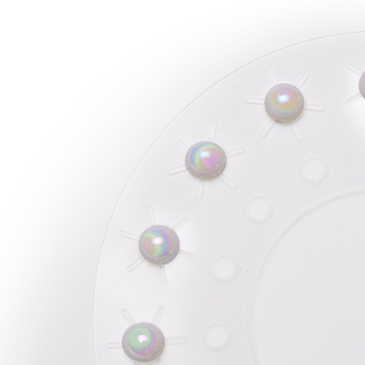 Close-up of four pearl earrings on a white background