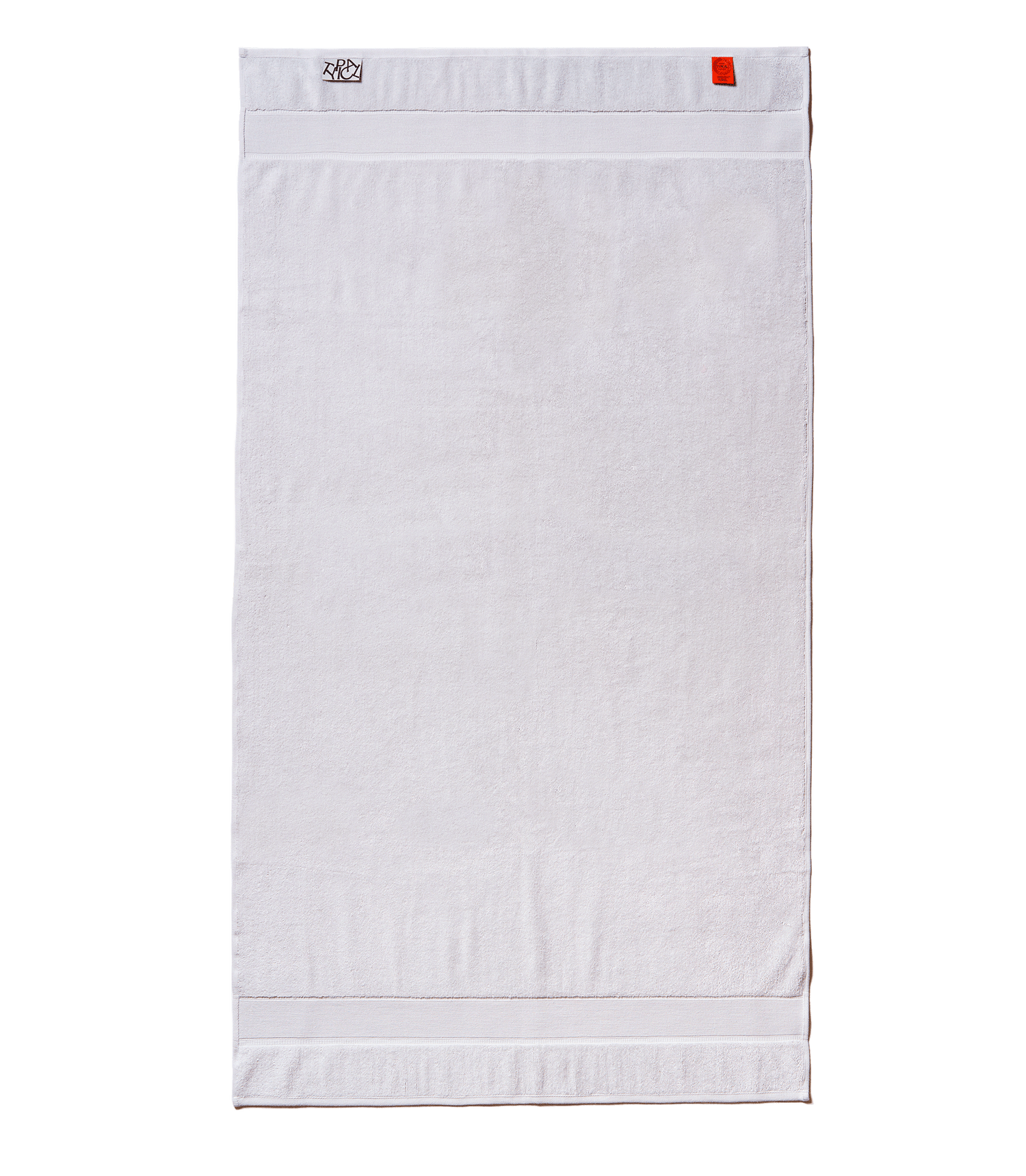 White towel with a brand label on a black background