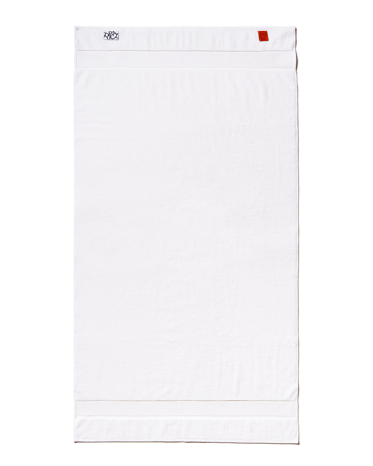 White towel with a brand logo on a black background