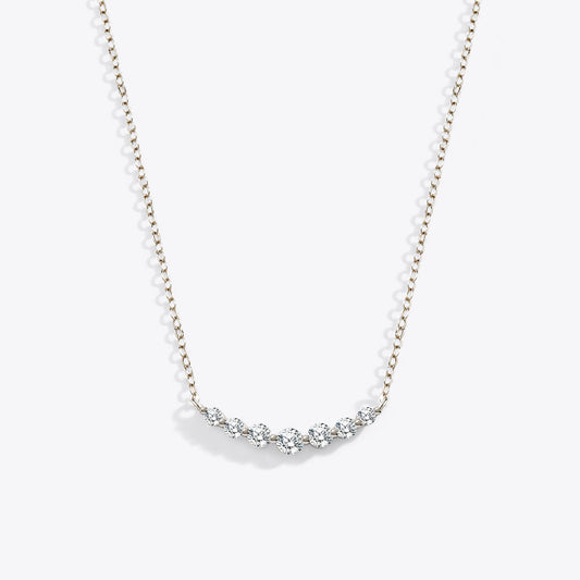 Gold necklace with small diamonds on a white background