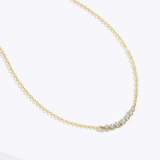 Gold necklace with small diamonds on a white background