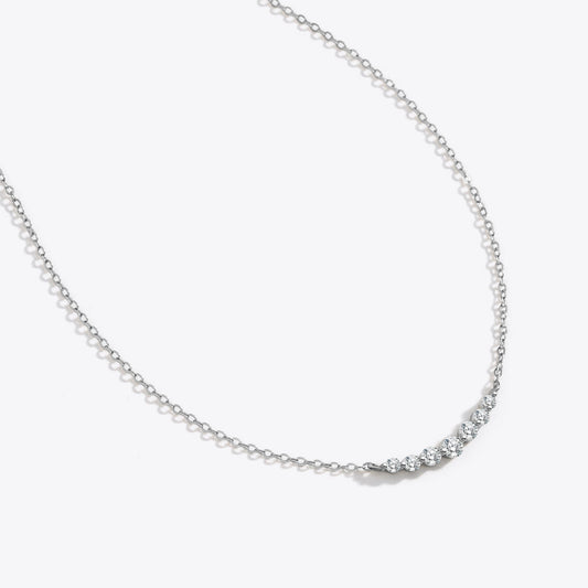 Gold necklace with small diamonds on a white background