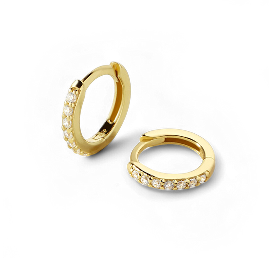 Gold hoop earrings with small diamonds on a white background