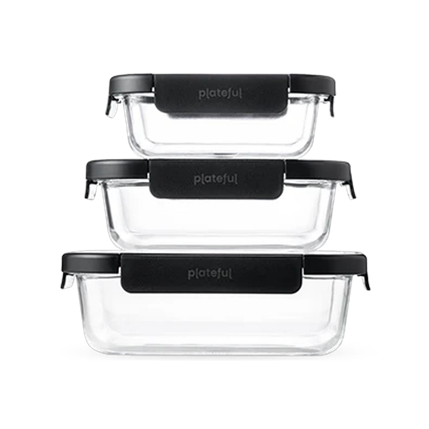 Set of three clear glass food containers with black lids on a white background