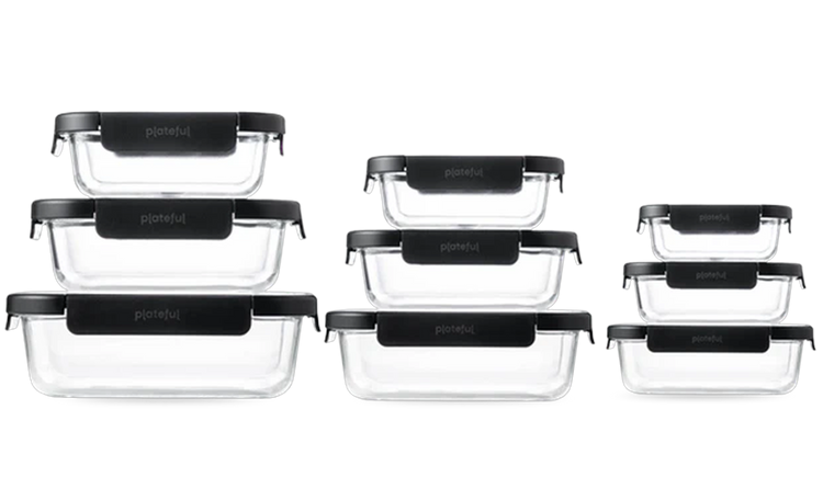 Set of glass food storage containers with black lids on a white background
