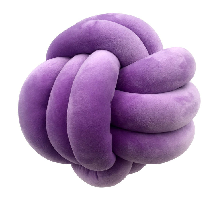 Purple knot-shaped pillow on a white background
