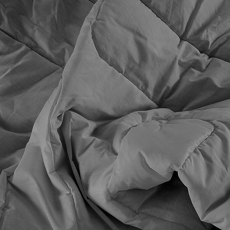 Close-up of a gray comforter with folds and texture