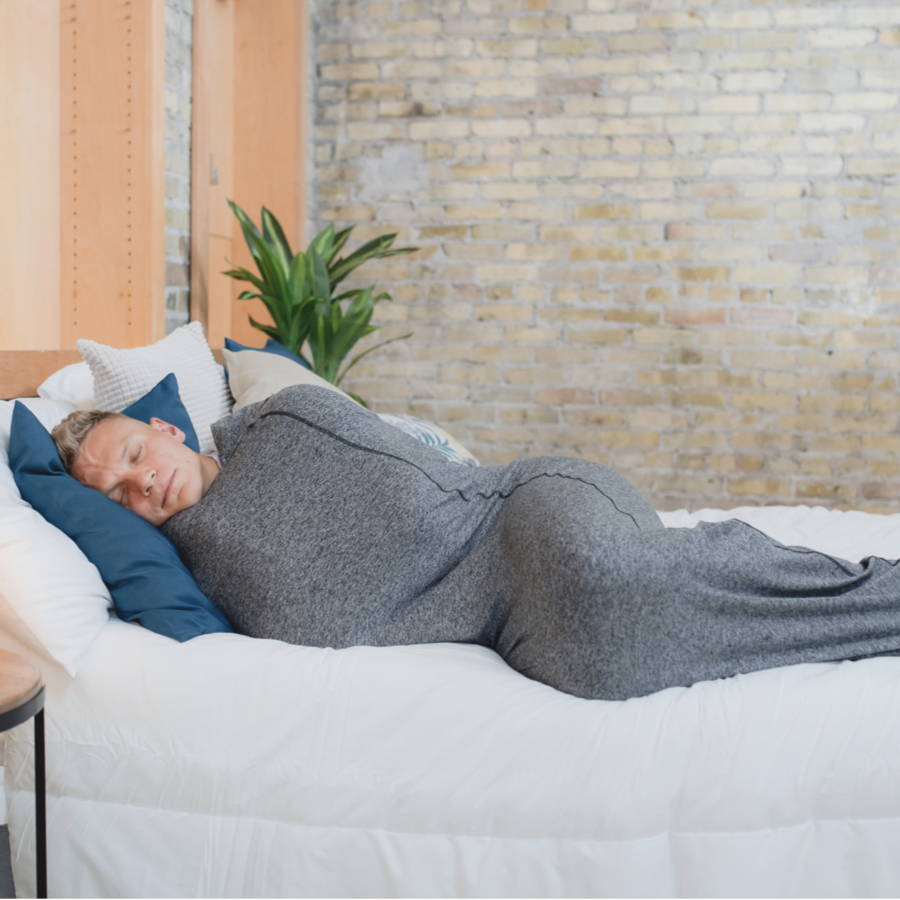 man laying in bed with sleep pod asleep