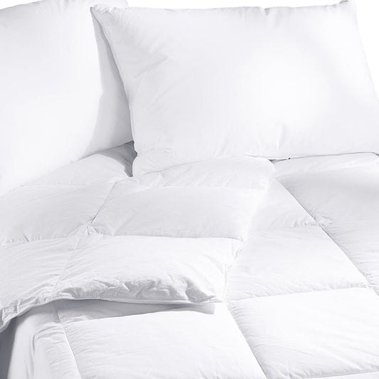 White comforter on a bed in a modern bedroom setting