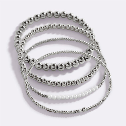 Silver beaded bracelet on a light gray background