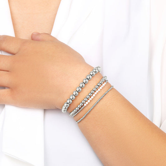 Silver beaded bracelet on a light gray background