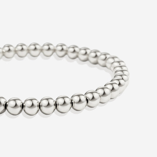 Silver beaded bracelet on a light gray background