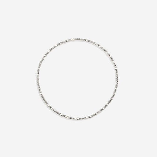 Silver beaded bracelet on a light gray background