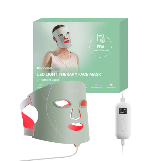 An LED light therapy face mask set shown with its mint green retail box, a gray mask emitting red light, and a white handheld controller on a plain white background. The box features the brand name 'nanoleal'.