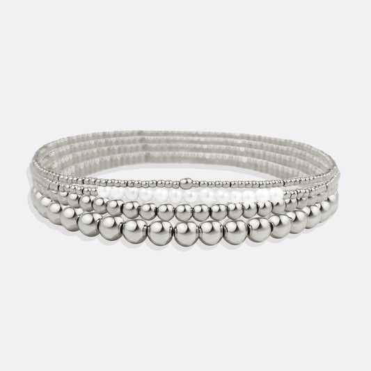 Silver beaded bracelet on a light gray background