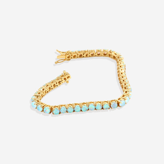 Gold bracelet with opal stones on a white background