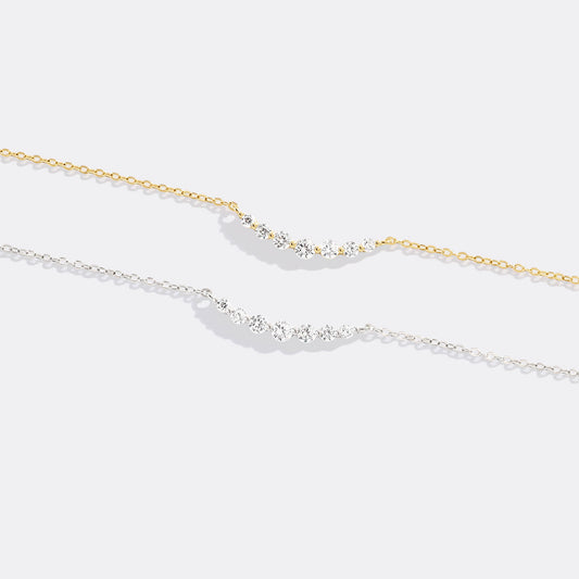 Gold necklace with small diamonds on a white background