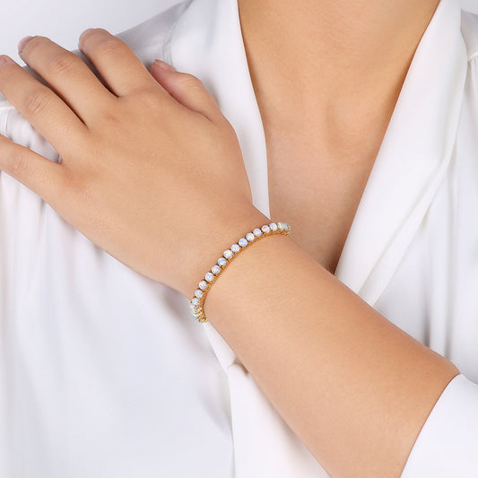 Gold bracelet with opal stones on a white background
