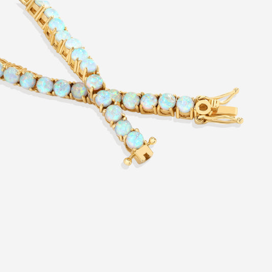Gold bracelet with opal stones on a white background