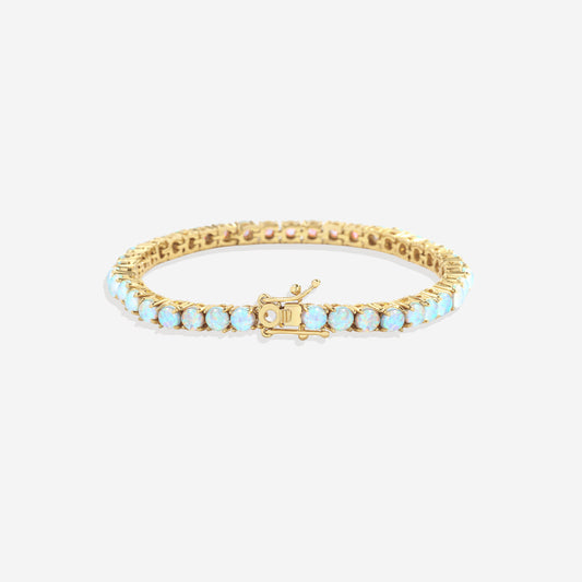 Gold bracelet with opal stones on a white background