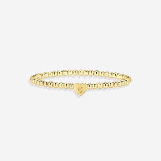 Gold beaded bracelet with a heart-shaped clasp on a white background