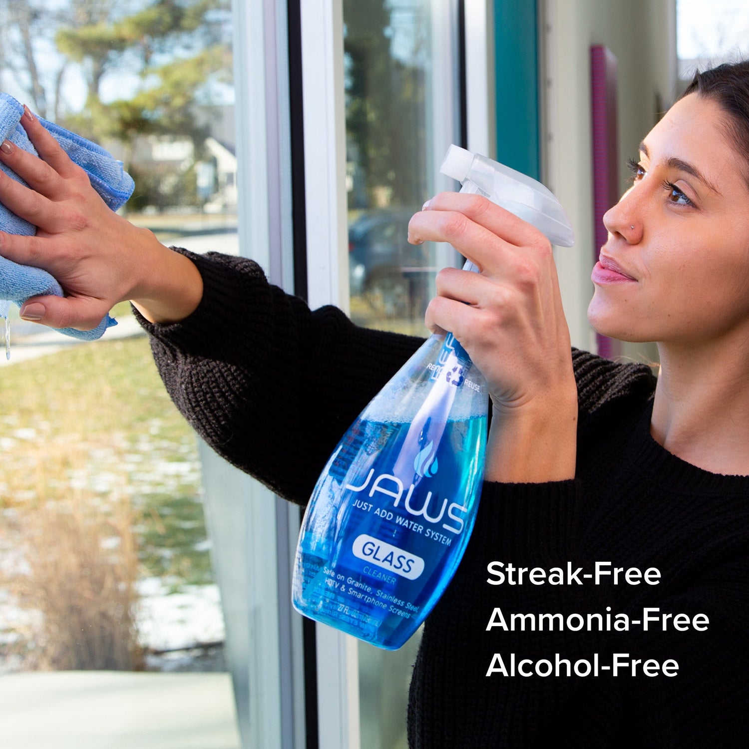 Woman cleaning a window with a spray bottle labeled 'JAWS' and text highlighting product features.
