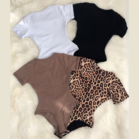 Leopard print bodysuit worn by a person on a white background