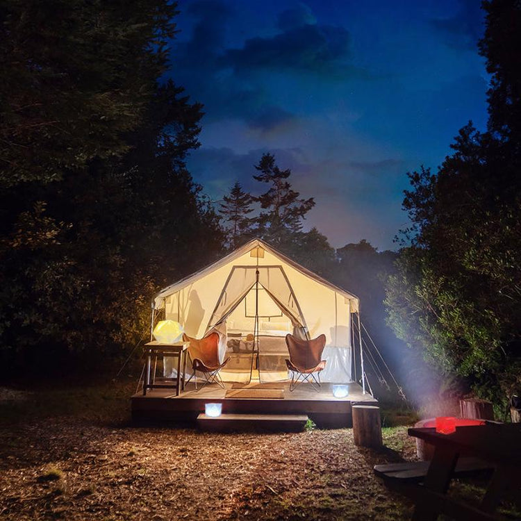 Helix Hybrid lantern in bright mode outside glamping tent for outdoor lighting