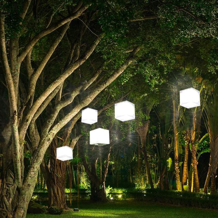 Helix Hybrid solar lanterns hanging in trees for ambient outdoor lighting