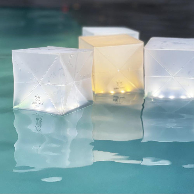 Multiple Helix Hybrid solar lanterns floating in a pool for ambient waterproof lighting